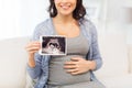 Close up of pregnant woman with ultrasound image Royalty Free Stock Photo