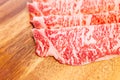 Close-up of Premium Rare Slices Wagyu A5 beef with high-marbled texture on square wooden plate served for Sukiyaki and Shabu Royalty Free Stock Photo