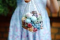 Close-up of preschool girl with bag with candy bonbons and lollipop. Different sweets in a bag. No face. Royalty Free Stock Photo