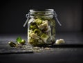 Close up preserved vegetables in jars on kitchen counter