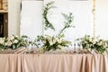 Close up of presidium with fresh flowers of the newlyweds at the wedding