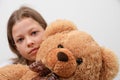 Close-up of the preteen girl with her teddy bear Royalty Free Stock Photo