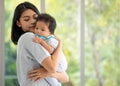 Close up pretty beautiful charming cute sweet lovely teen mother embrace her adorable baby boy Royalty Free Stock Photo