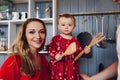 Pretty blonde mom with little daughter cooking together at kitchen. Royalty Free Stock Photo