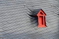 Tiny Medieval Red Dormer Window on Grey Slate Roof Royalty Free Stock Photo