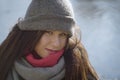 Close-up of pretty smiling Caucasian girl in grey hat and scarf. Portrait of happy brunette woman at the background of Royalty Free Stock Photo