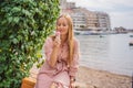 Close up of pretty tourist girl eating traditional gelato italian ice cream in a European town Royalty Free Stock Photo