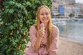 Close up of pretty tourist girl eating traditional gelato italian ice cream in a European town Royalty Free Stock Photo