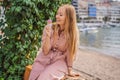 Close up of pretty tourist girl eating traditional gelato italian ice cream in a European town Royalty Free Stock Photo