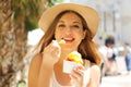 Close up of pretty tourist girl eating traditional gelato italian ice cream in Sirmione, Italy Royalty Free Stock Photo