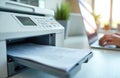 Close up of printer prints documents in office. Person works on laptop. Printing paperwork, technology, workspace in daylight Royalty Free Stock Photo