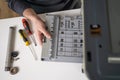 printer repair technician. A male handyman inspects a printer before starting repairs in a client's apartment.