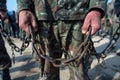 Close up of a prisoner s hand gripping chains, capturing the struggle and resilience of captivity Royalty Free Stock Photo