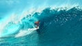 CLOSE UP: Pro surfer surfs a big barrel wave in popular surf spot in Tahiti.