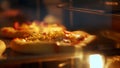 close-up, the process of baking mini pizza from yeast dough in a large industrial oven. Baking bread in an industrial