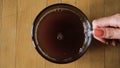 Close-up of process of brewing instant coffee in cup. Concept. Top view of stages of adding ingredients for instant
