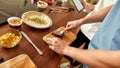 Close up of process of cooking. Man preparing meal while woman checking recipe using tablet. Vegetarians cooking in the Royalty Free Stock Photo