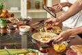 Close up of process of cooking. Man preparing meal while woman checking recipe using tablet. Vegetarians cooking in the Royalty Free Stock Photo