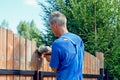 Close-up of the process of cutting the fence with a jigsaw. A man aligns the fence with a jig saw on a country plot. Royalty Free Stock Photo