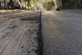 Close-up of the process of repair of the road paving road asphalt application. Roadworks on laying of a new of asphalt