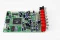 A close-up of the processor microchip surrounded by other electrical components on a green circuit board. Also on the board is a
