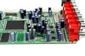 A close-up of the processor microchip surrounded by other electrical components on a green circuit board. Also on the board is a