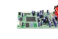 A close-up of the processor microchip surrounded by other electrical components on a green circuit board. Also on the board is a