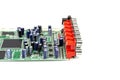 A close-up of the processor microchip surrounded by other electrical components on a green circuit board. Also on the board is a