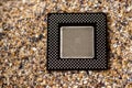 Close-up of a processor with sand in the background