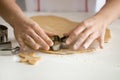 Close up of professional confectioner hands cutting gingermen Royalty Free Stock Photo