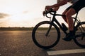 Close up of cyclist with strong legs racing on road Royalty Free Stock Photo