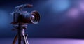 Professional digital camera mounted on tripod with lens and flash in studio lighting setup with blue and purple background Royalty Free Stock Photo