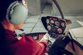 Close up of professional female pilot using aircraft control system