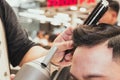 Close-up professional hairdresser using scissors and clippers and accessories for beautiful and decorating men hair Cutting hair