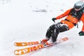 Close-up Professional laughing Skier athlete rides out of deep snow while performing a skiing trick in a snowstorm. The