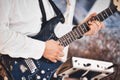 Close-up of a man`s hands playing the fretboard of an electric blues guitar Royalty Free Stock Photo