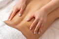 Close-up professional masseuse performing with hand back massage to young woman client in wellness spa center, beauty photo Royalty Free Stock Photo