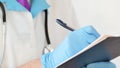 Close-up of professional therapist hands signing medical document on clipboard. Royalty Free Stock Photo