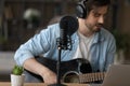 Close up professional microphone, man playing guitar, recording song Royalty Free Stock Photo