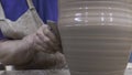 Close-up of professional Potter creating pitcher of clay. Stock footage. Masterful work of Potter with clay in process