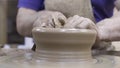 Close-up of professional Potter creating pitcher of clay. Stock footage. Masterful work of Potter with clay in process