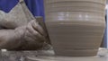 Close-up of professional Potter creating pitcher of clay. Stock footage. Masterful work of Potter with clay in process