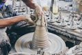 Close up professional potter`s hand making Thai style pot lid on a potter`s wheel in pottery villages at Ko Kret, Nonthaburi Royalty Free Stock Photo