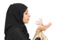 Close up of a profile of an arab woman smelling a flower