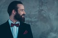 Close-up profile side view portrait of his he nice attractive classy cheerful cheery bearded guy wearing tuxedo for