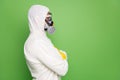 Close-up profile side view portrait of his he nice content professional disinfectant wearing gas mask anti sars n-cov-2