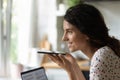 Close up profile of smiling woman recording audio message