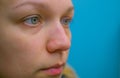 Close-up profile view, of woman eye. Isolated on a blue background Royalty Free Stock Photo