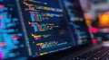 Close up of programming code on a laptop screen with blurred background. AIG53F.