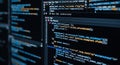 Close-up of programming source code on dark-themed IDE across multiple screens, symbolizing software development, coding, and Royalty Free Stock Photo